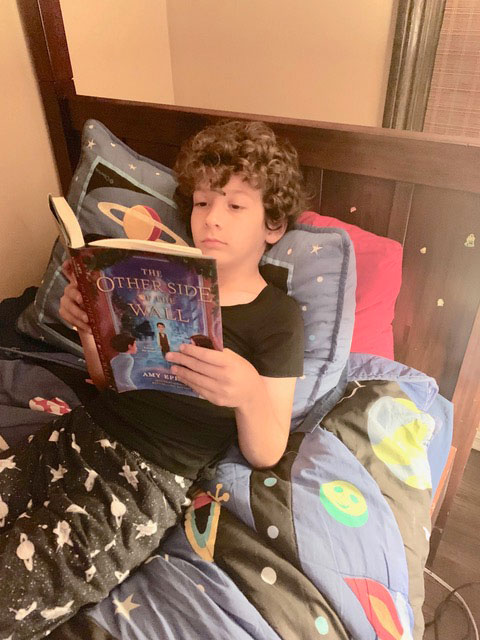 Jude reading #TheOtherSideoftheWall in his amazing room which Tess & Max (and I) think is magical.